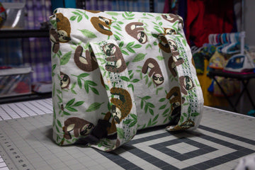 Handcrafted Sloth Pattern Dog Care Backpack with Green Accents and Pet Essentials