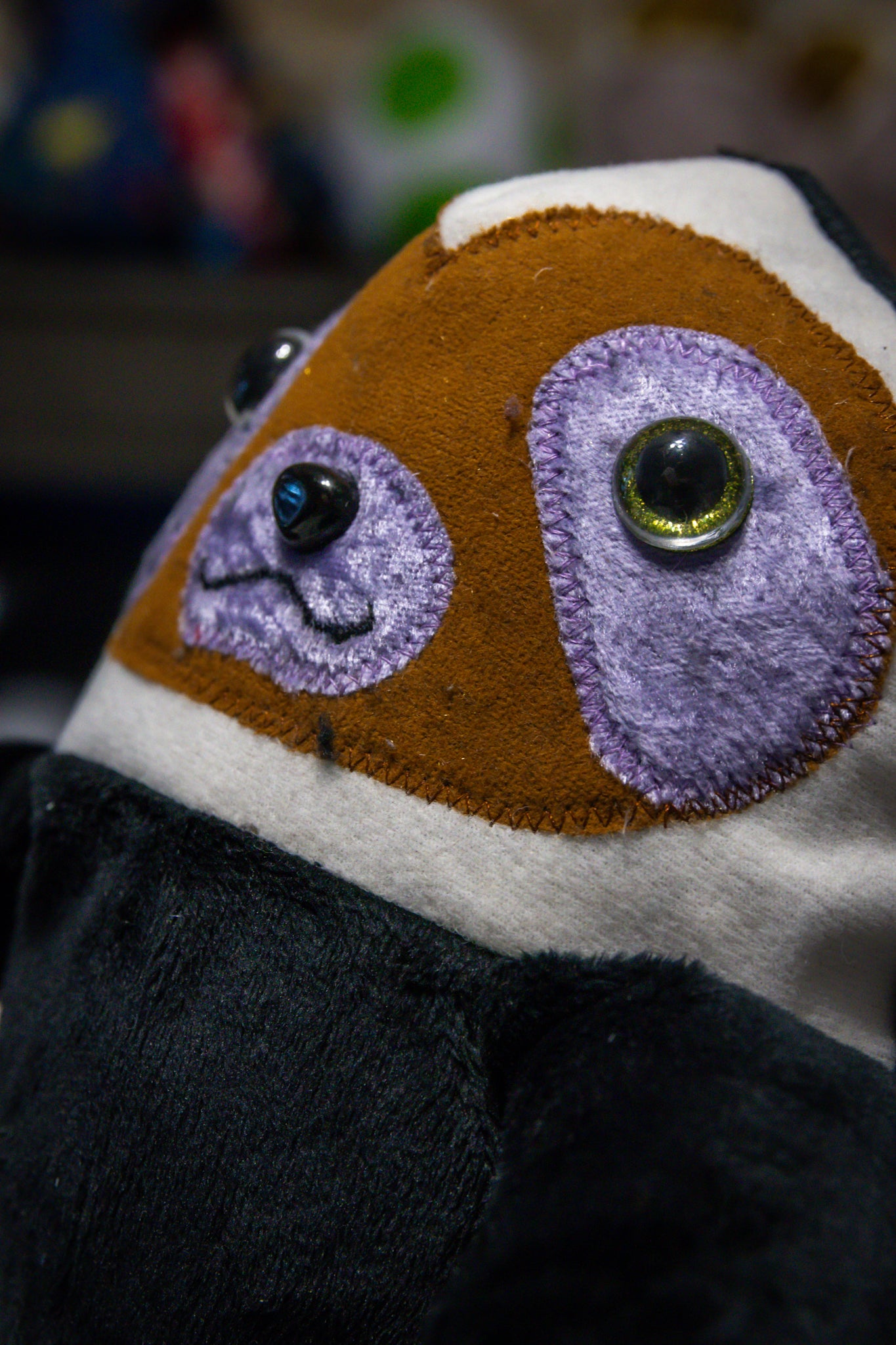 Handcrafted Black Velcro Sloth Plush with Orange Face and Red Eye Accents