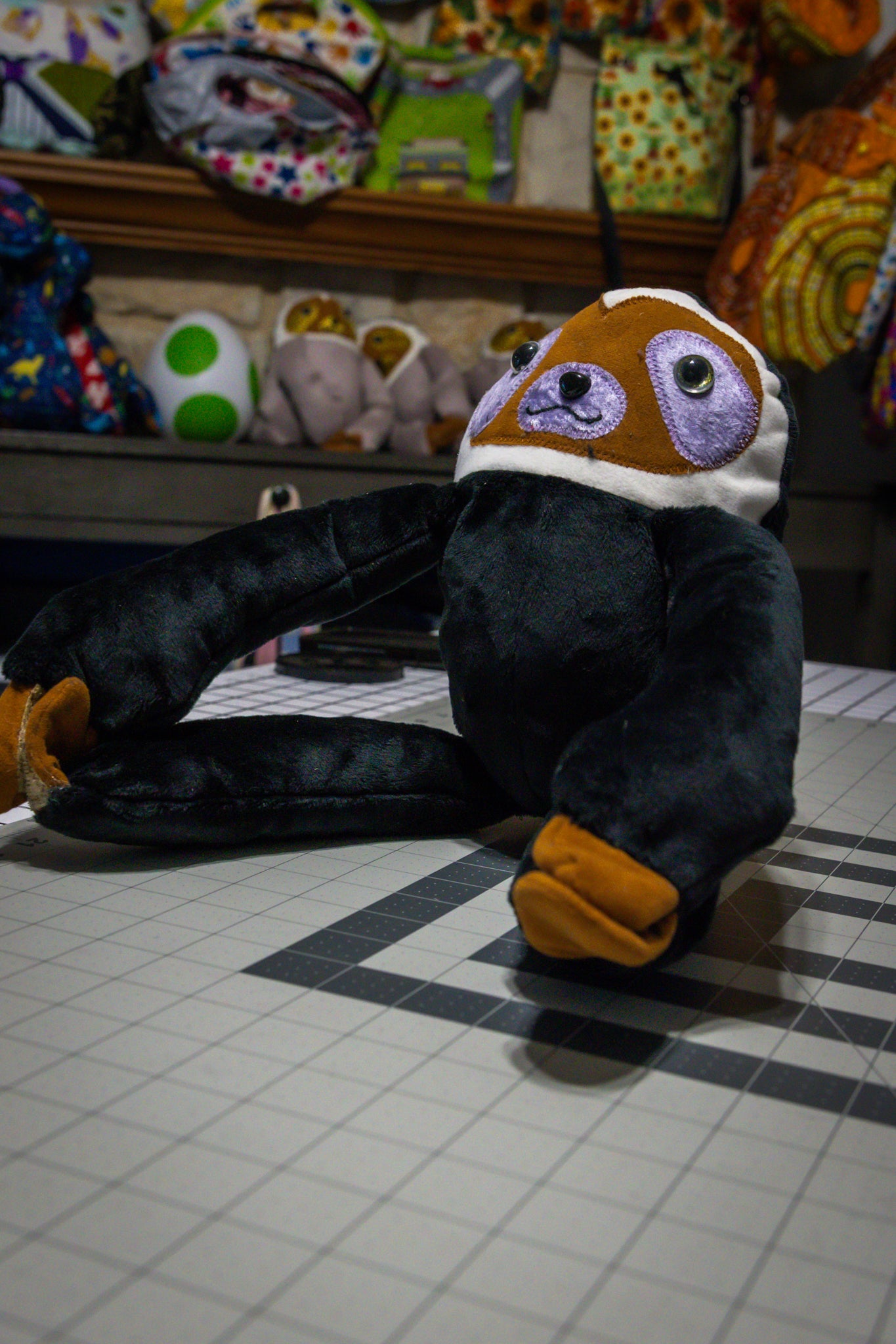 Handcrafted Black Velcro Sloth Plush with Orange Face and Red Eye Accents