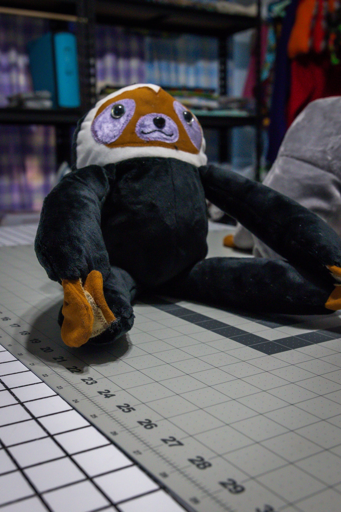 Handcrafted Black Velcro Sloth Plush with Orange Face and Red Eye Accents