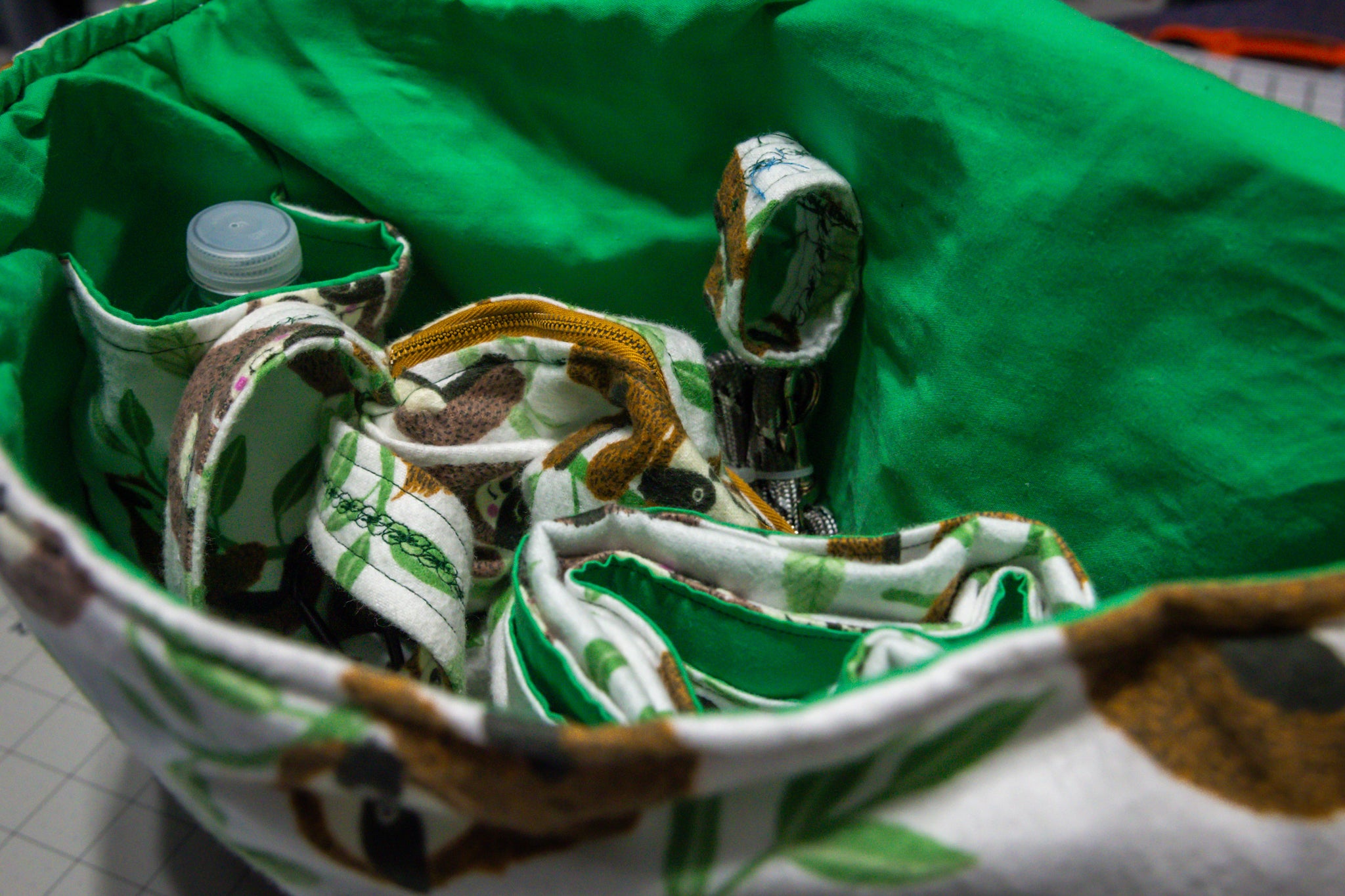 Handcrafted Sloth Pattern Dog Care Backpack with Green Accents and Pet Essentials