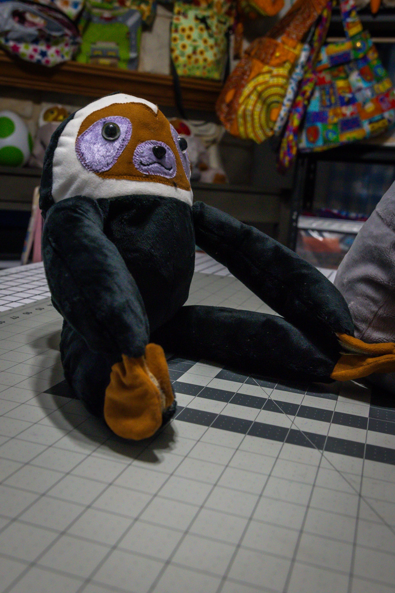 Handcrafted Black Velcro Sloth Plush with Orange Face and Red Eye Accents