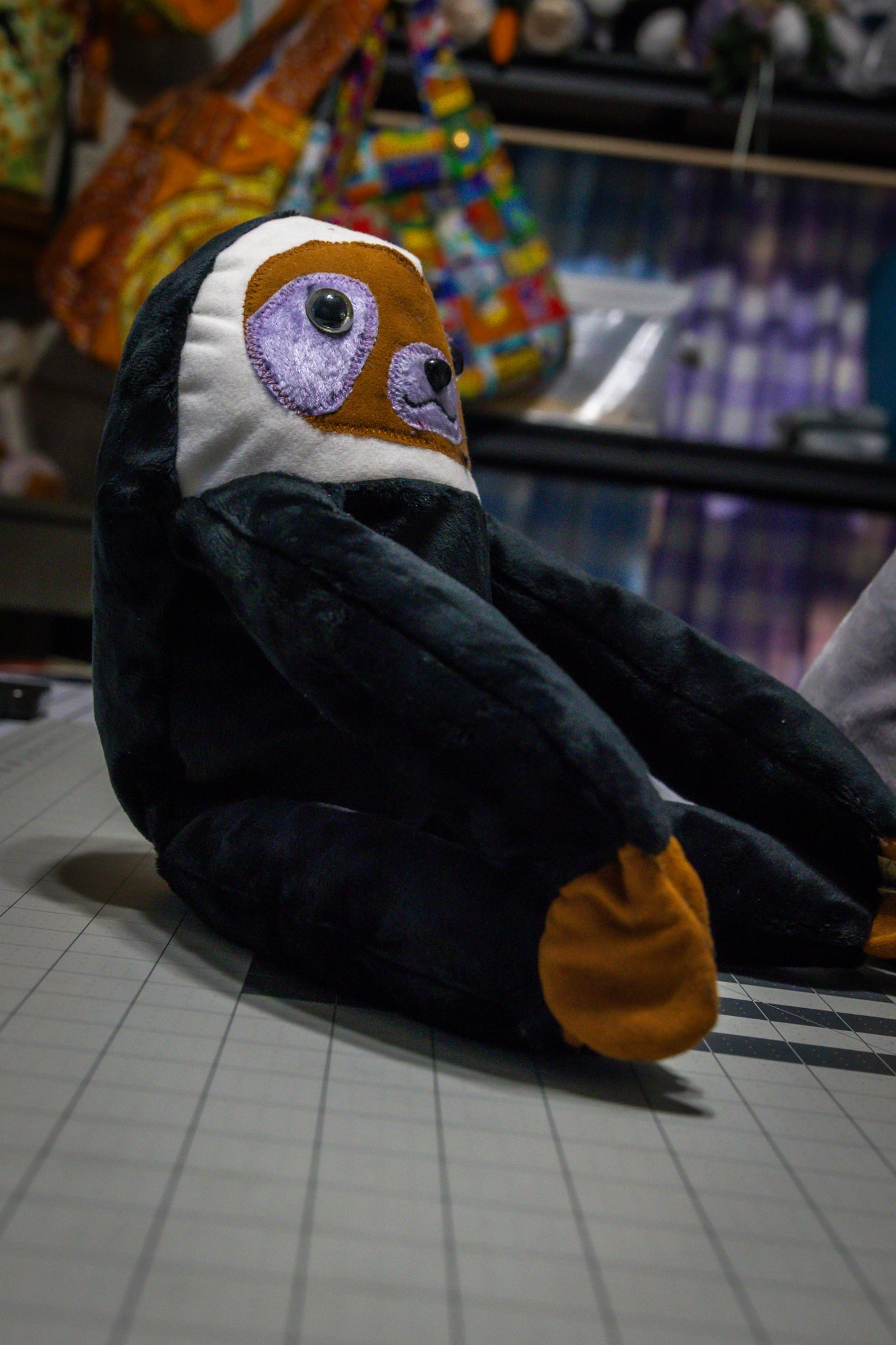 Handcrafted Black Velcro Sloth Plush with Orange Face and Red Eye Accents