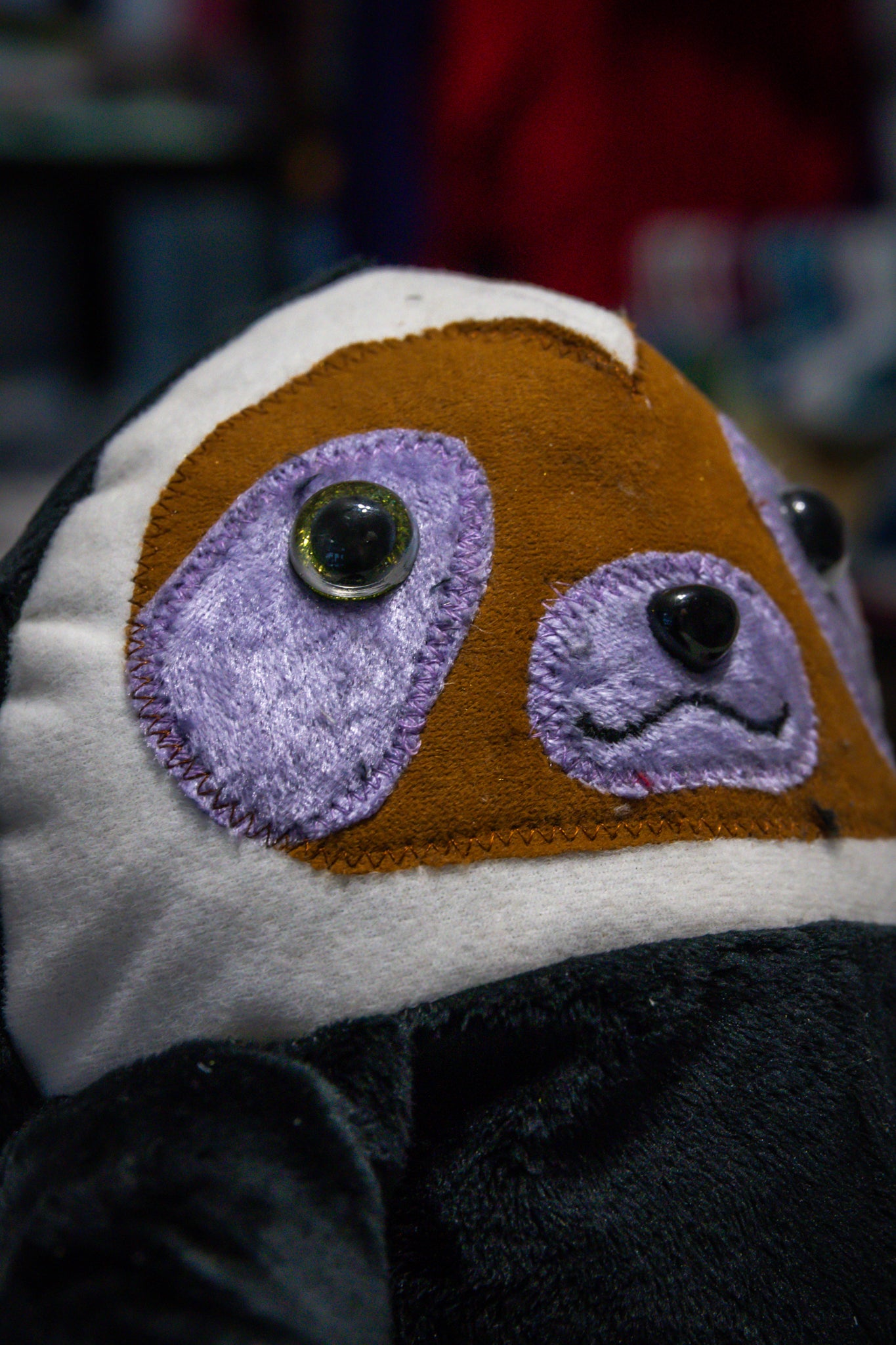 Handcrafted Black Velcro Sloth Plush with Orange Face and Red Eye Accents